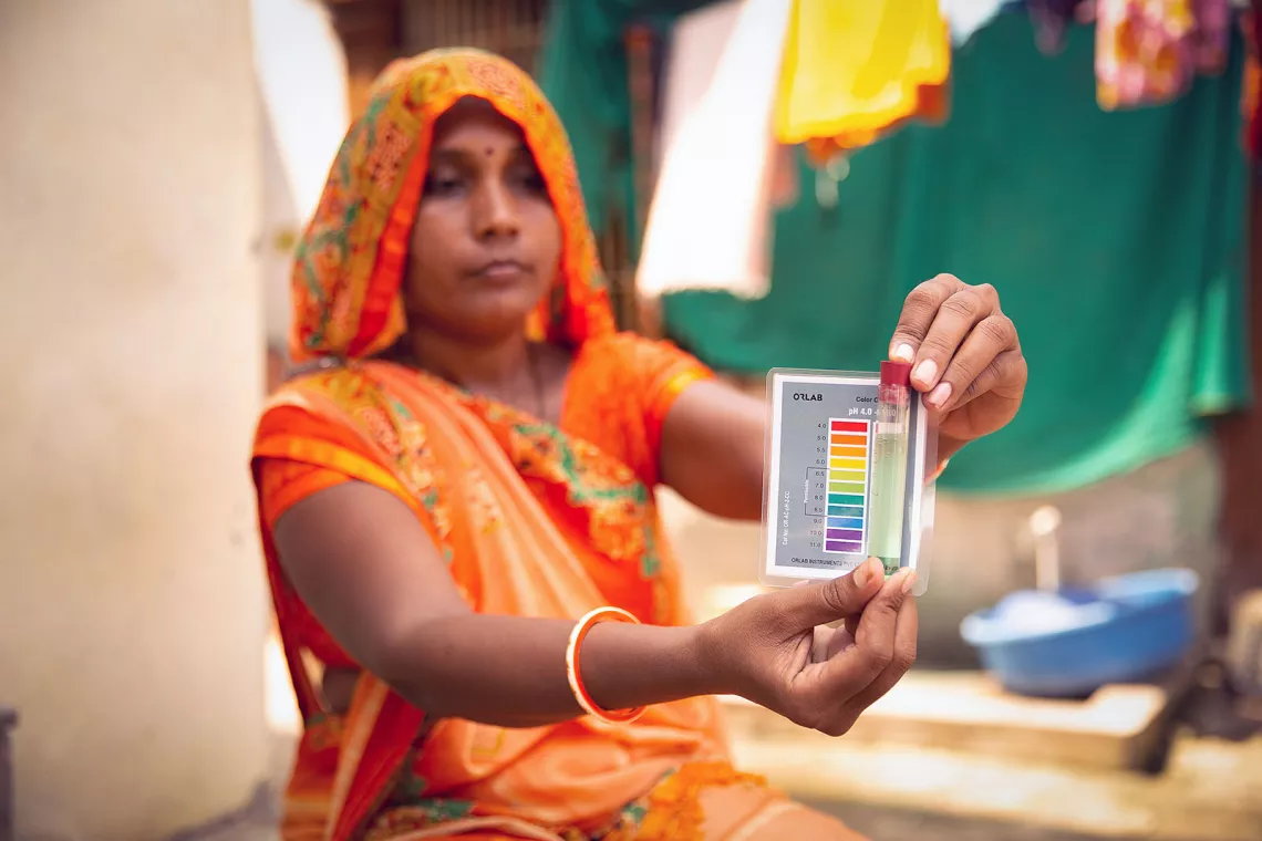 A woman tests water in Gujarat, India using a kit delivered by UNICEF.