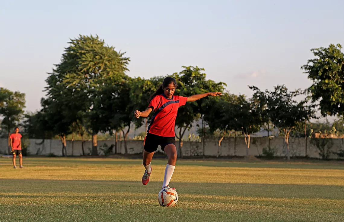 Nisha Rawat, 15, tries to score a penalty kick during a match in the Makadwali area in the Ajmer district, Rajasthan