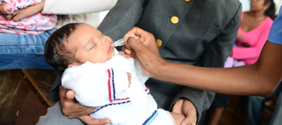 A baby is vaccinated by a health professional in Madagascar, in October 2015.