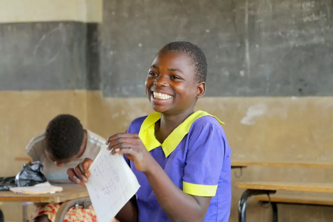 Lucy Chalire smiles after she completes her end of year mathematics exam at Namera Primary school, in Malawi, September 2017.