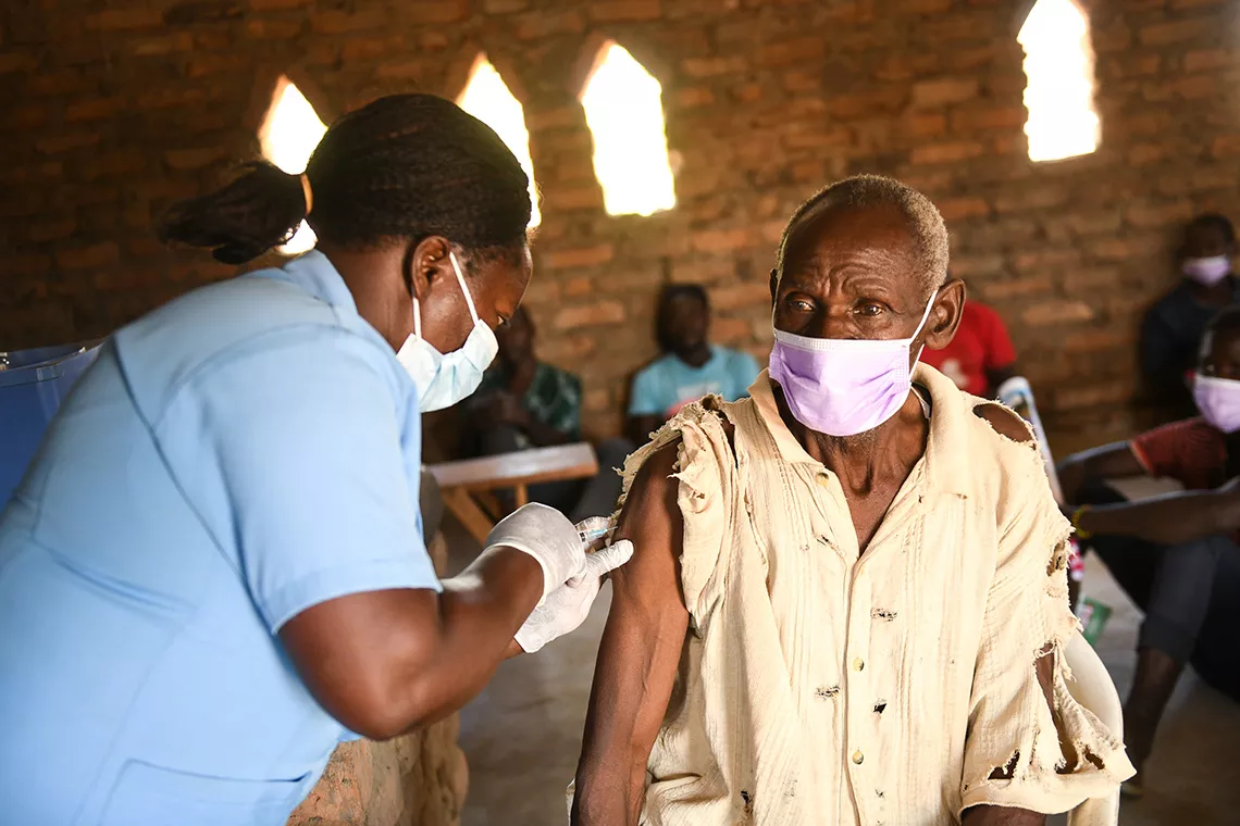72-year-old Wiseborn Banda receives a COVID-19 vaccine in Kasungu, Malawi 