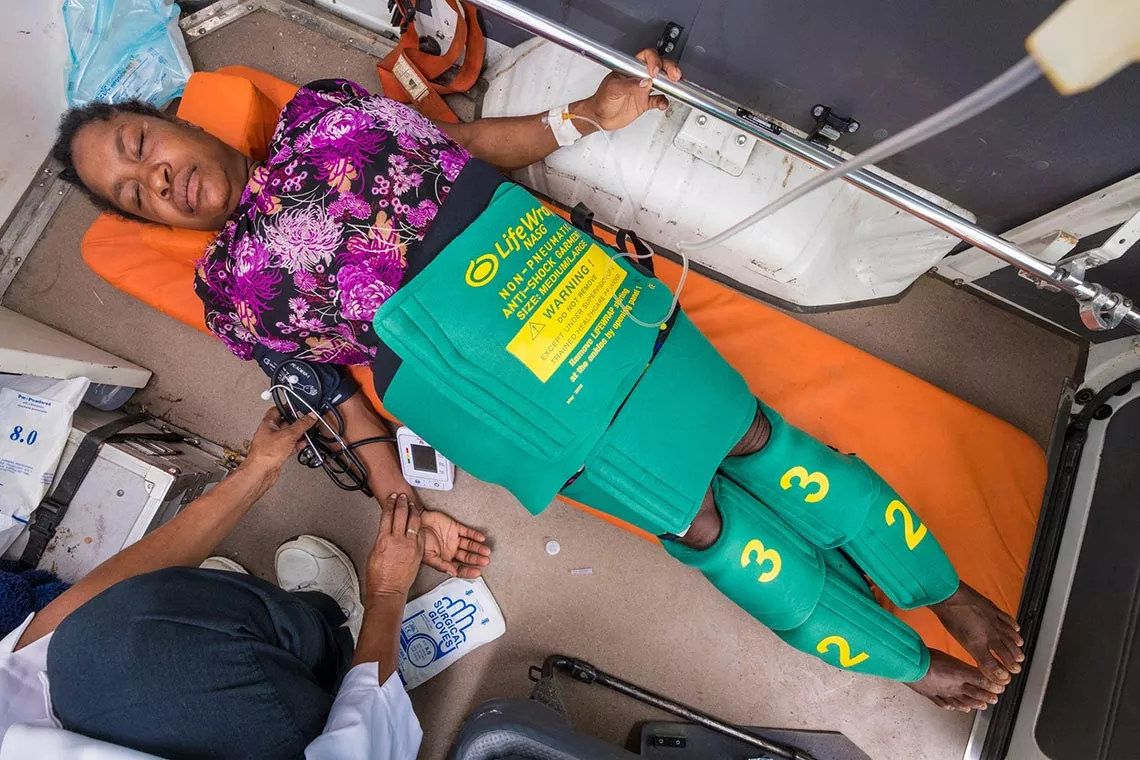 A woman demonstrates how the Non-pneumatic Anti-Shock Garment is used at a health clinic in Papua New Guinea.
