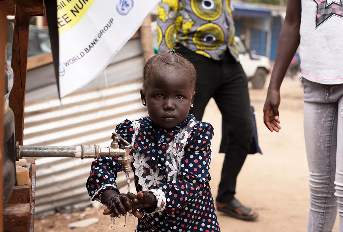 A girl washes her hands using one of recently established handwashing stations in the Konyo market in South Sudan capital Juba.