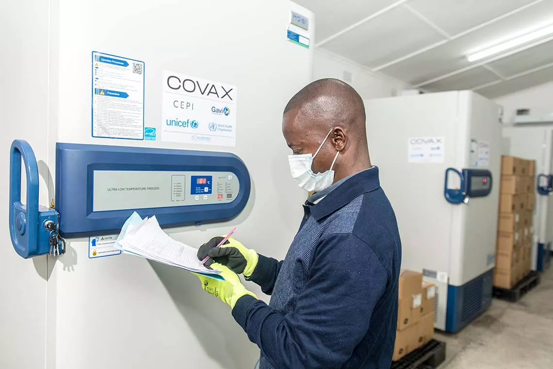 A health official monitors the temperature of an ultra-cold chain freezer storing mRNA COVID-19 vaccines at ultra-low temperatures in Zambia. 