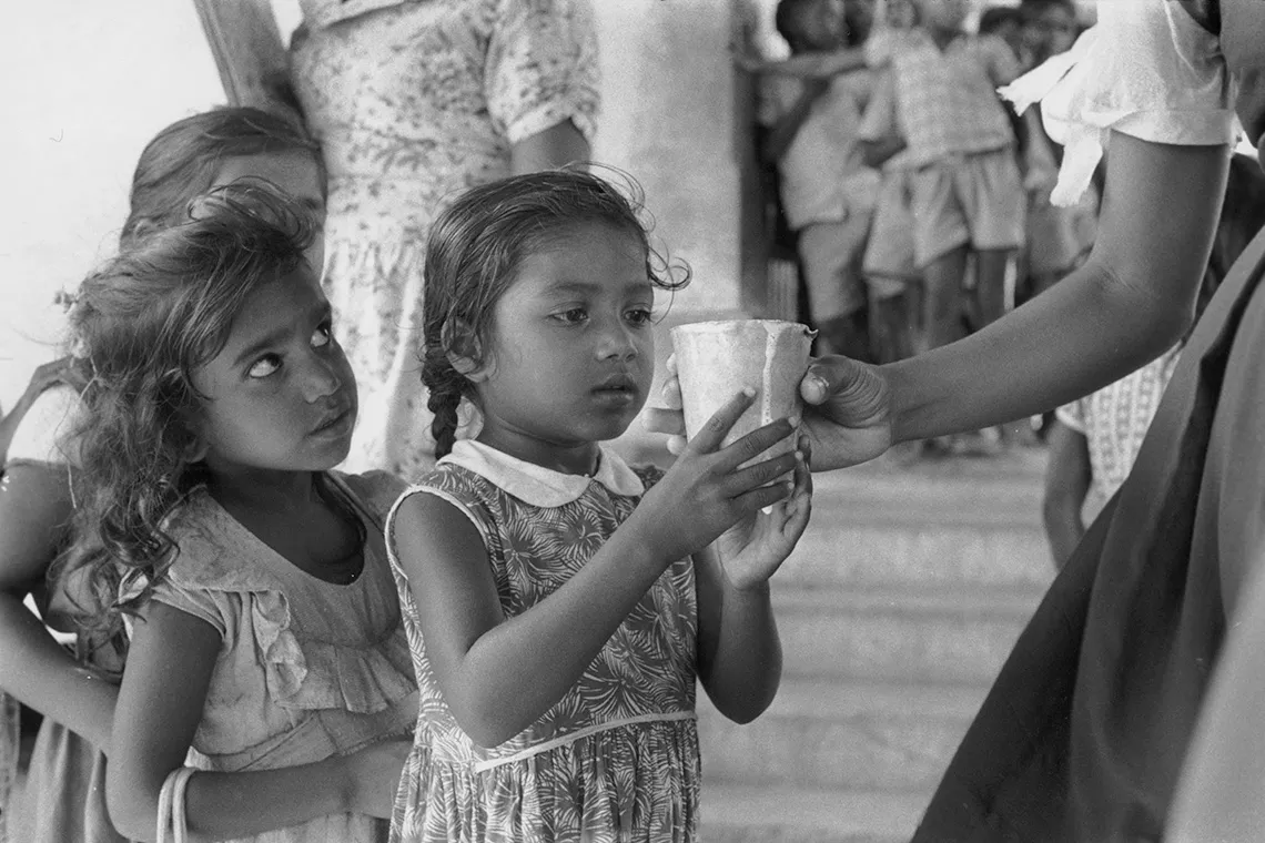 School children in Trinidad receive their daily ration of milk. 