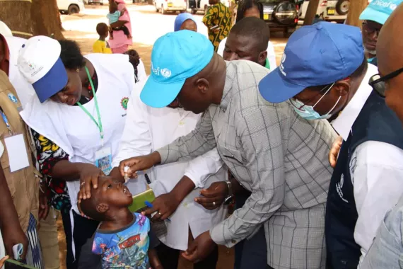 Child receives vaccine from health officials.