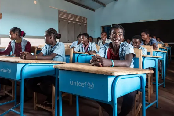 A group of young people sitting at desks in a classroom