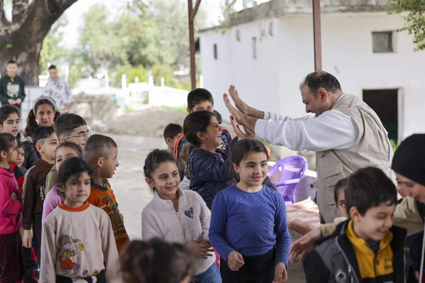 UNICEF team interact with children as they take part in a UNICEF-supported recreational activity, part of the psychosocial support services provided to children in rural Lattakia.