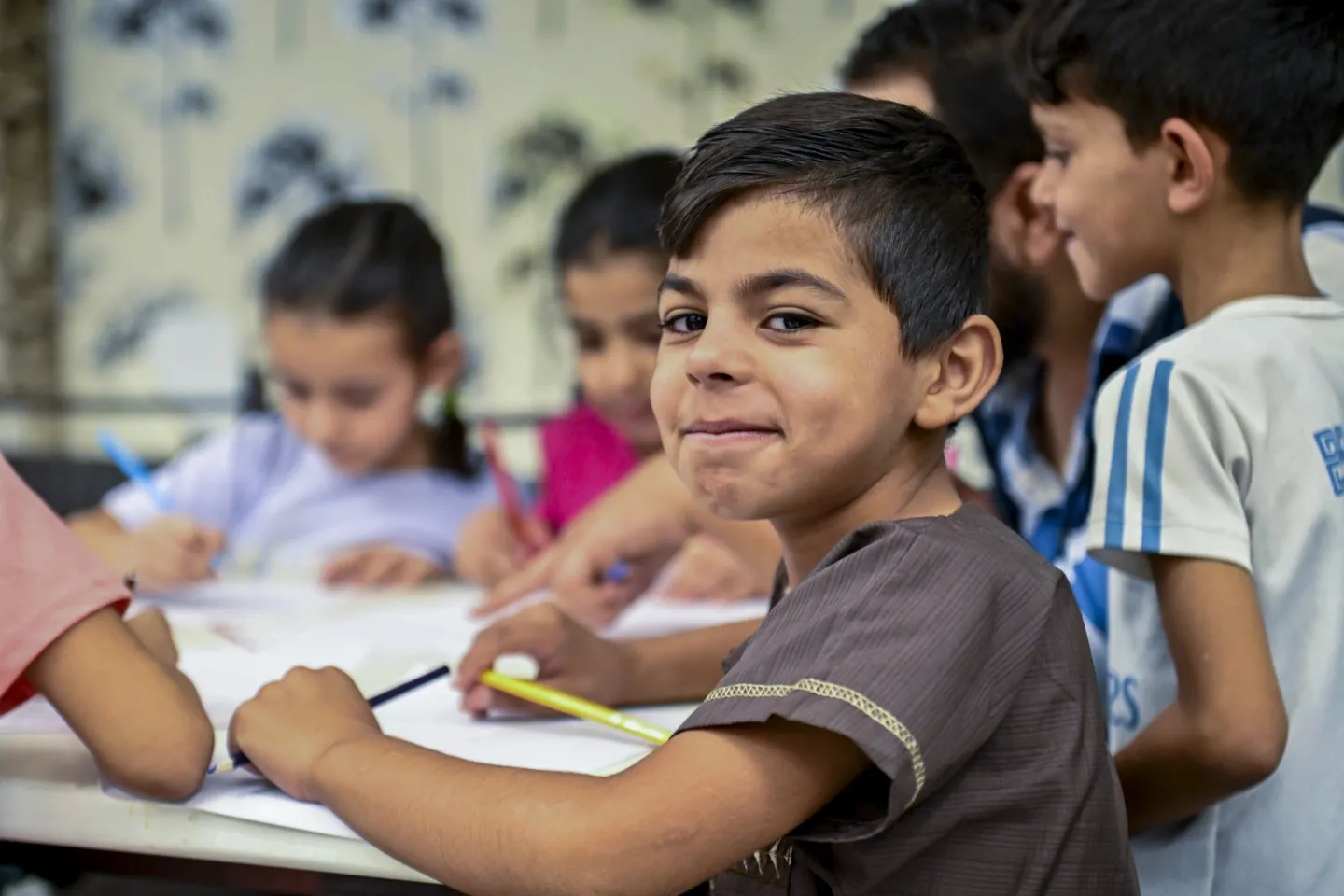 Anas, 8, takes part in a drawing activity provided by a UNICEF-supported child protection team at a shelter in Sayyeda Zeinab, Rural Damascus.