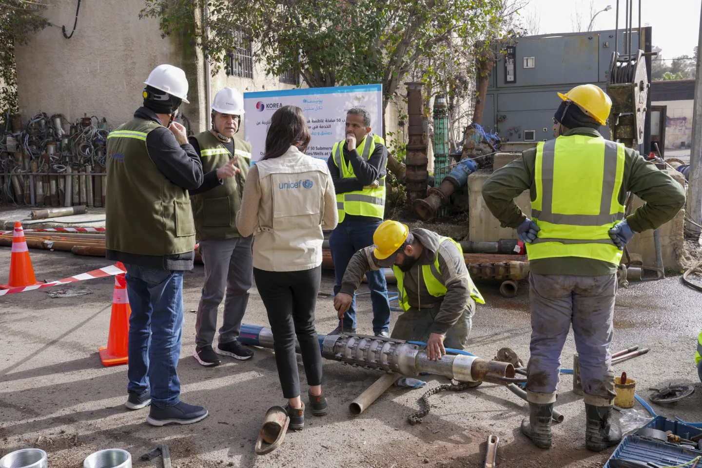 UNICEF&rsquo;s Water and Sanitation Officer reviews progress with the implementing team during preparations to install a submersible pump in a groundwater well.