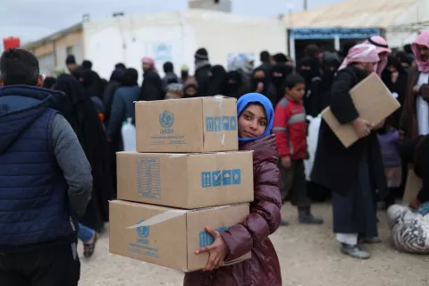 girl carrying UNICEF boxes