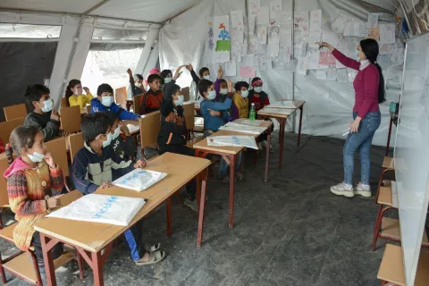 children in a classroom tent