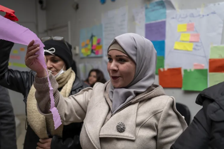 A woman holds onto a pink ribbon.
