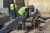 Workers prepare new pipes for installation.