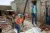 A UNICEF officer oversees work progress as workers carry out backfilling of a sewage channel.