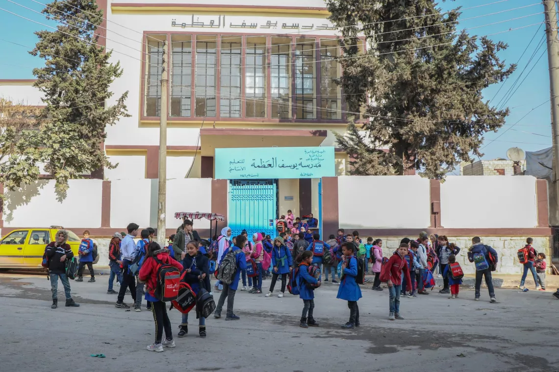 Students gathered in front of a school 