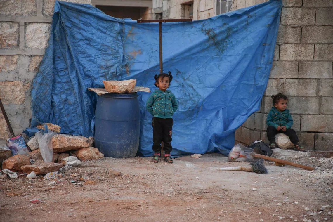Child play in front of tent in a camp 