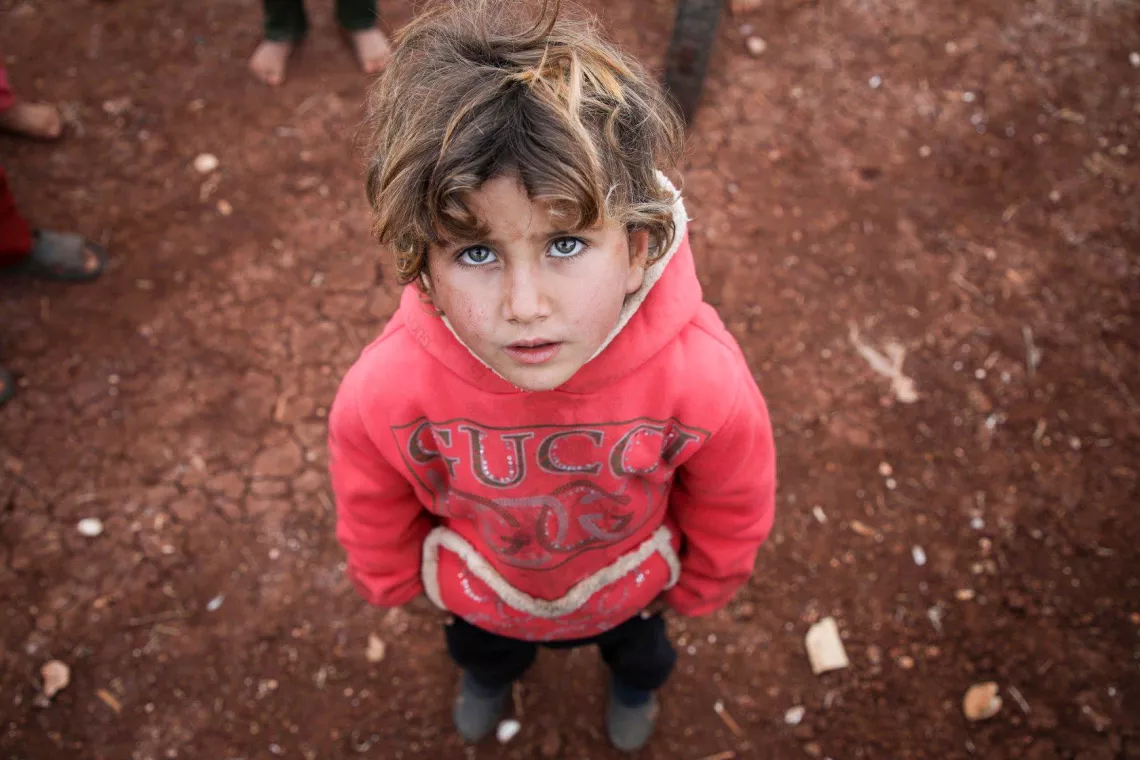 child in a camp looking to camera