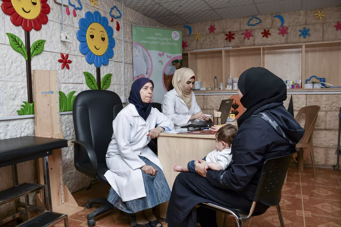Mother and baby sitting in the doctor's room for a consultation with the paediatician