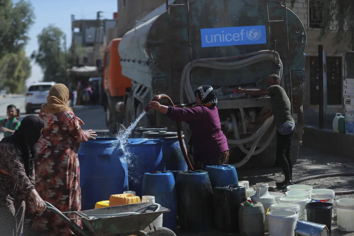 women-filling-water-drums