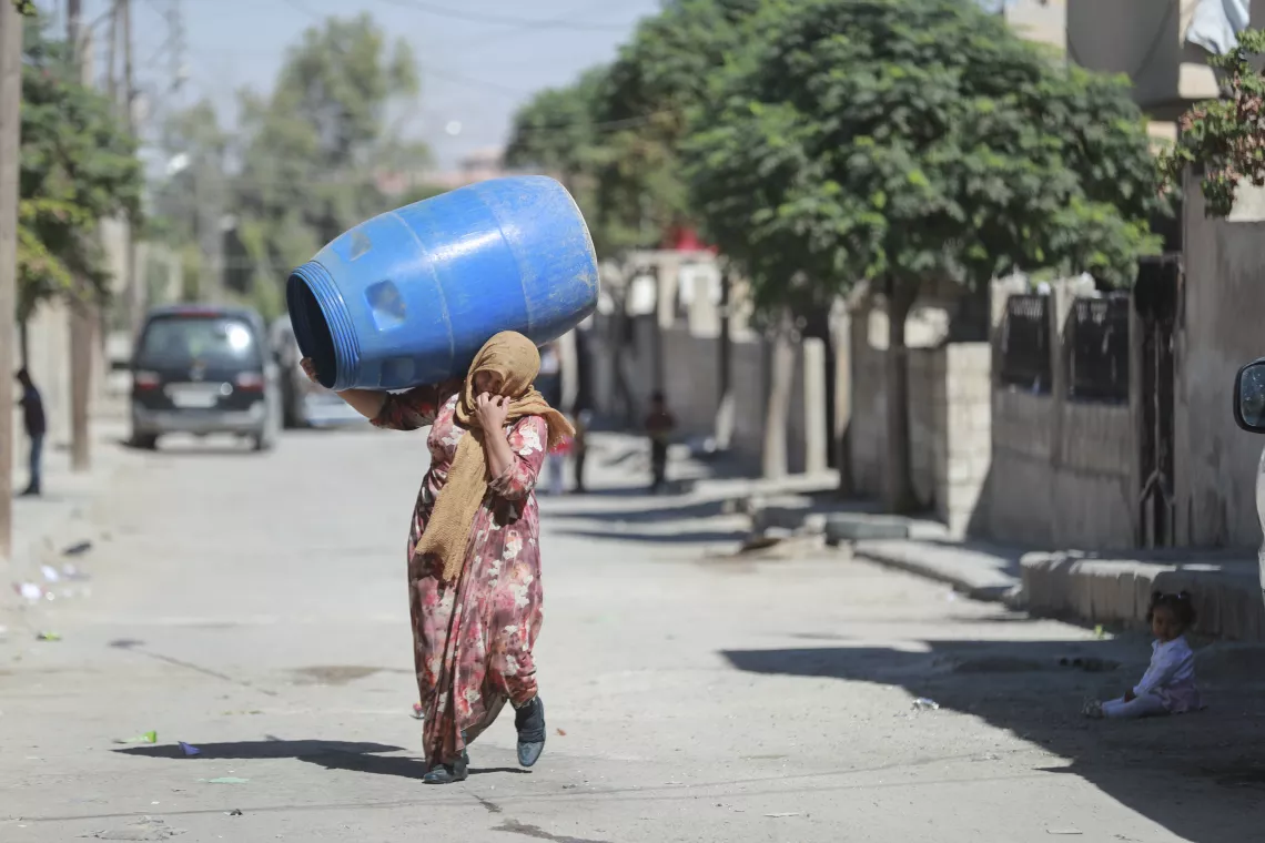 woman-carrying-water-barrel