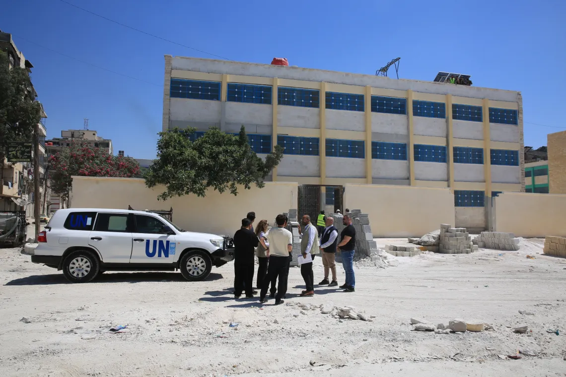 H.E. the Ambassador of the Republic of Korea discusses the progress of rehabilitation works with a group of official outside the school.