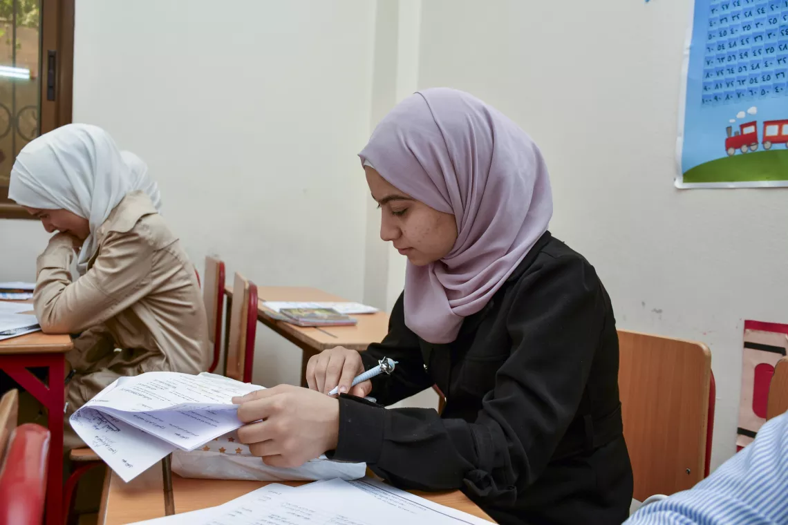 Nour, 20, revises her lessons in preparation for her Grade 9 science exam.