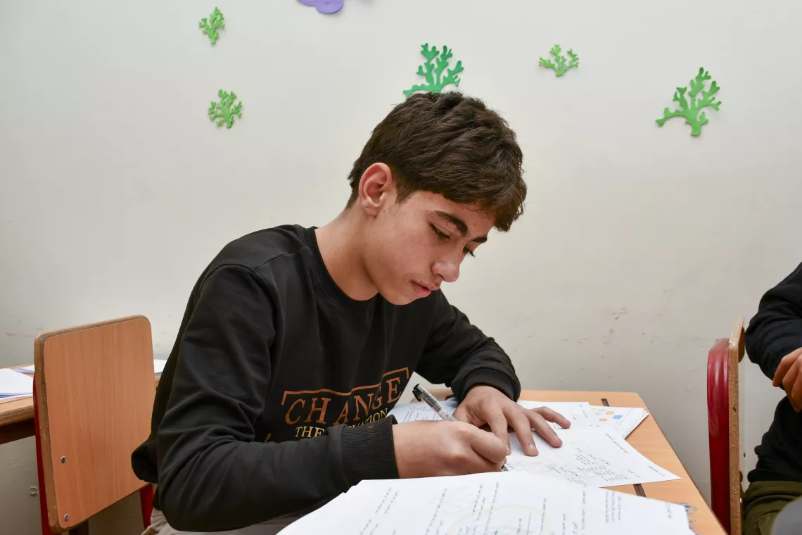 Khaled, 16, focuses during a Grade 9 science session.