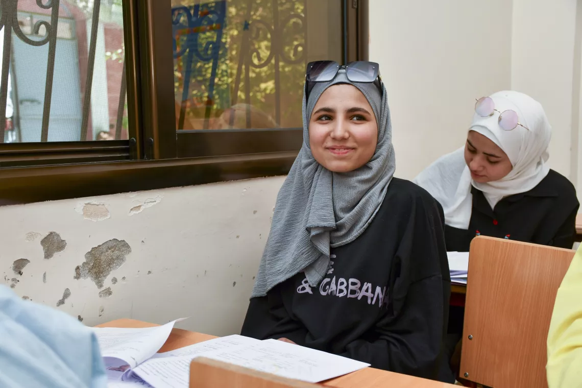 Tasneem, 17, smiles during a science revision class.