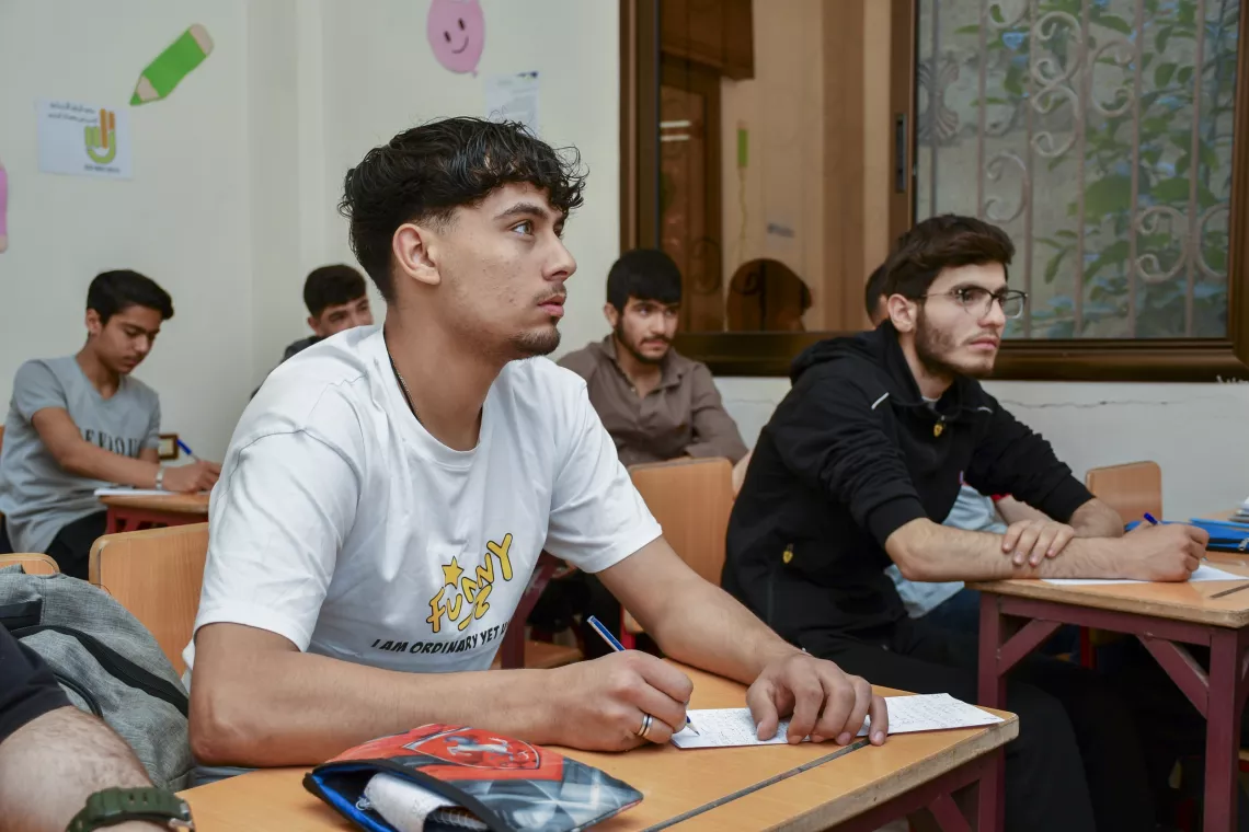 Farouk, 18, revises a mathematics lesson. 