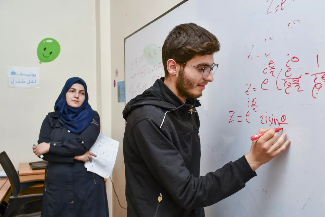 Abdulrahman, 19, goes through mathematics exam questions.