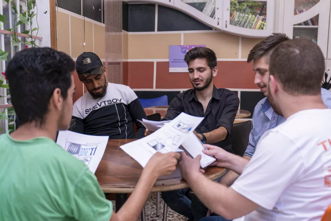 Elia, 17, reviews what he learned during a mobile phone maintenance course with his classmates at a UNICEF-supported youth-friendly space in Jaramana, Rural Damascus.