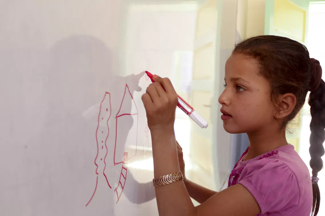 student girl drawing on whiteboard 