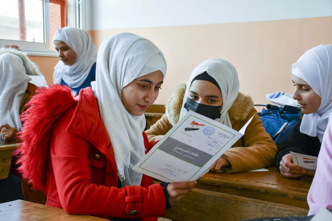 girl reading in book in class room