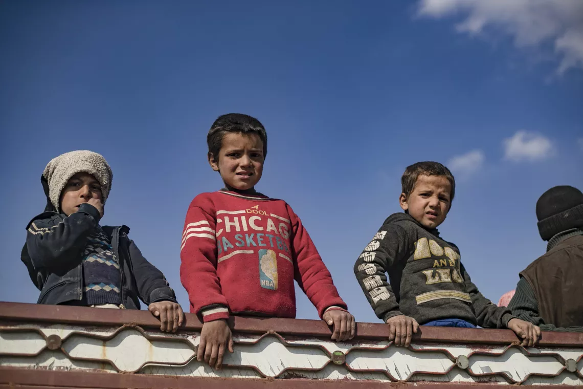 children fleeing in a truck