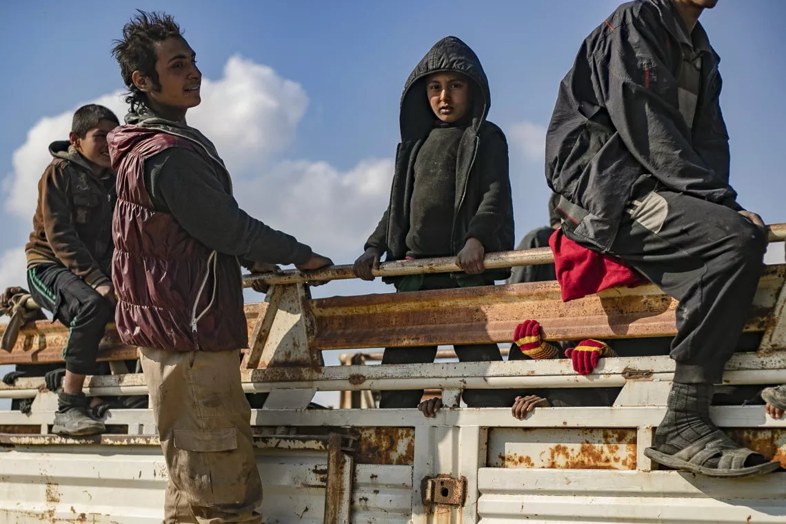 children fleeing in a truck