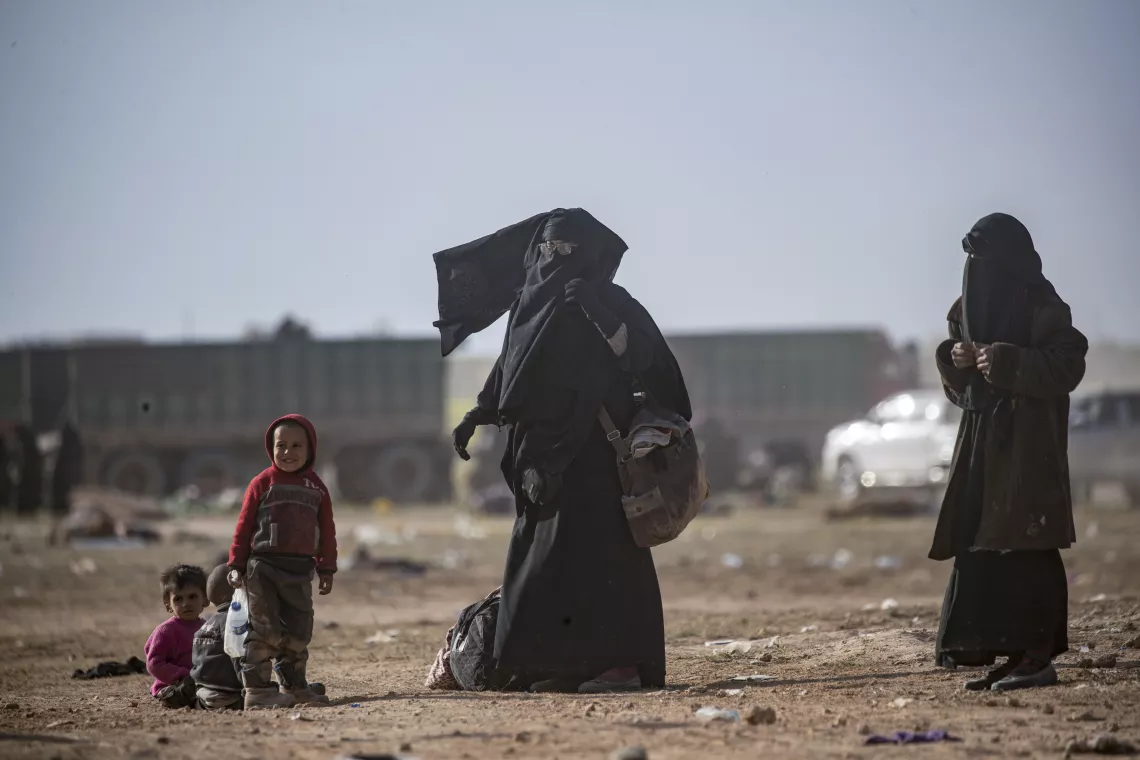 children and women fleeing in desert