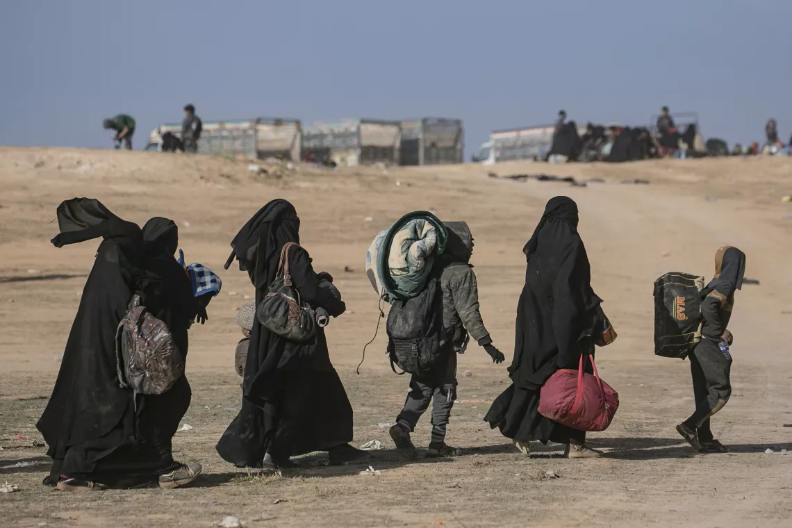women and children fleeing in the desert