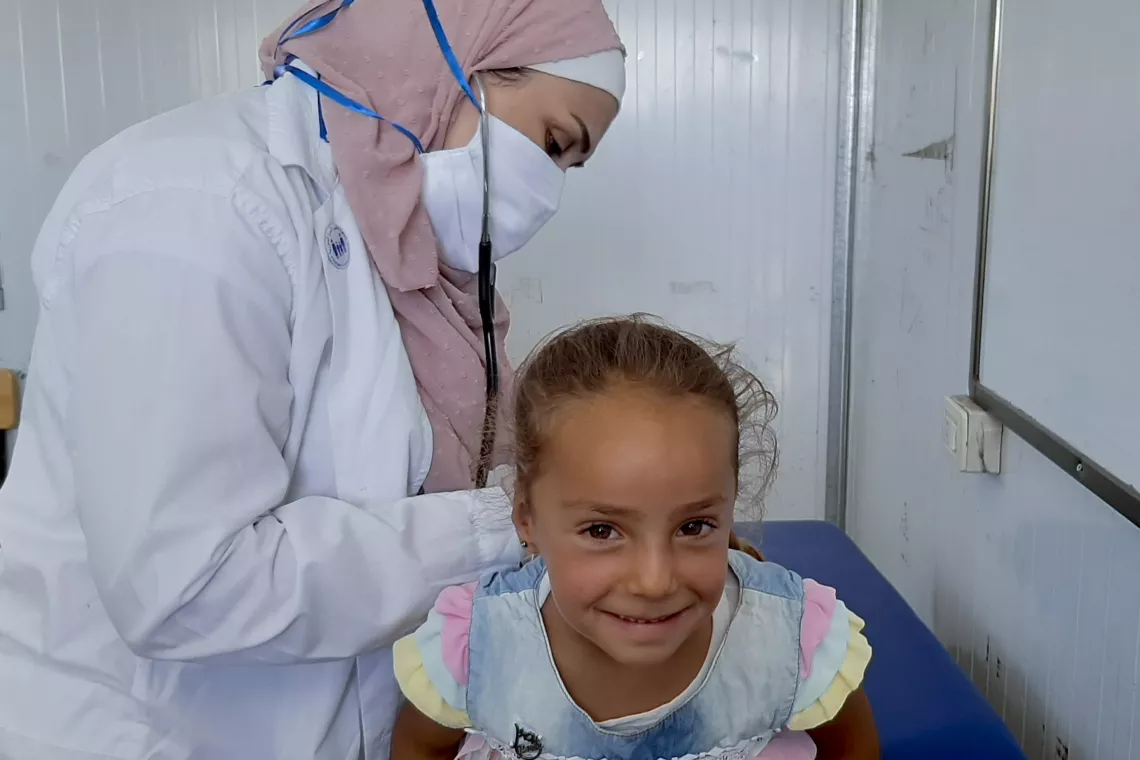 female doctor checking little girl in a clinic 