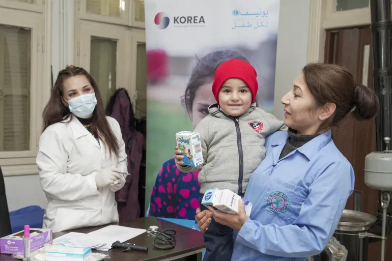 Nojoud and her three year old son, Nour, receive medicine from Dr Samia.