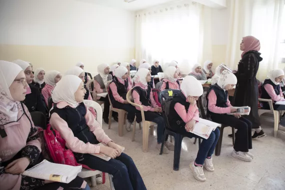 Girls working attentively in the classroom.