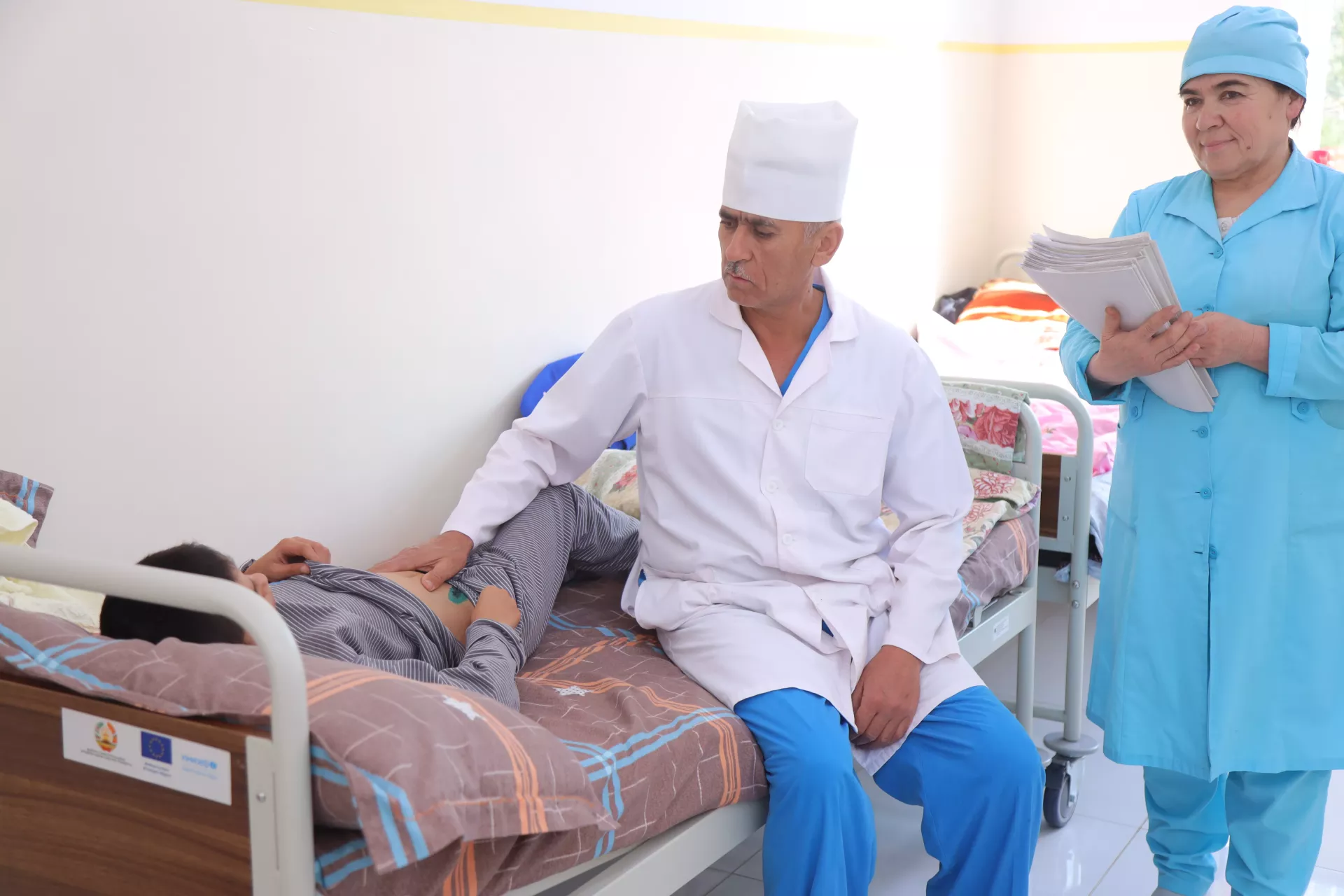 A doctor examining his child patient 