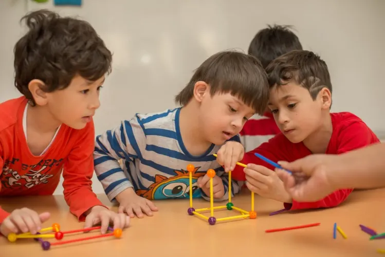 A child with Down syndrome is playing with his peers