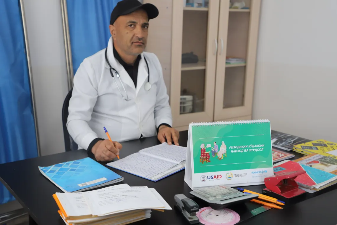 A doctor making notes in his records