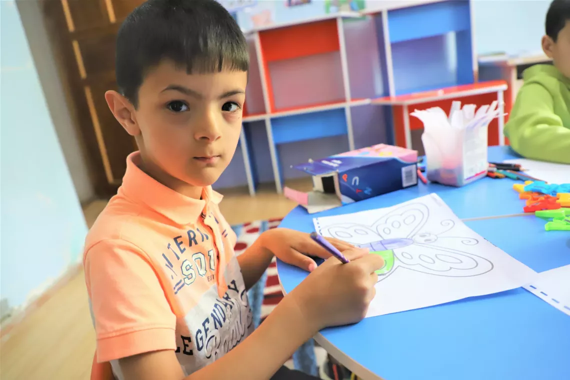a little boy is drawing