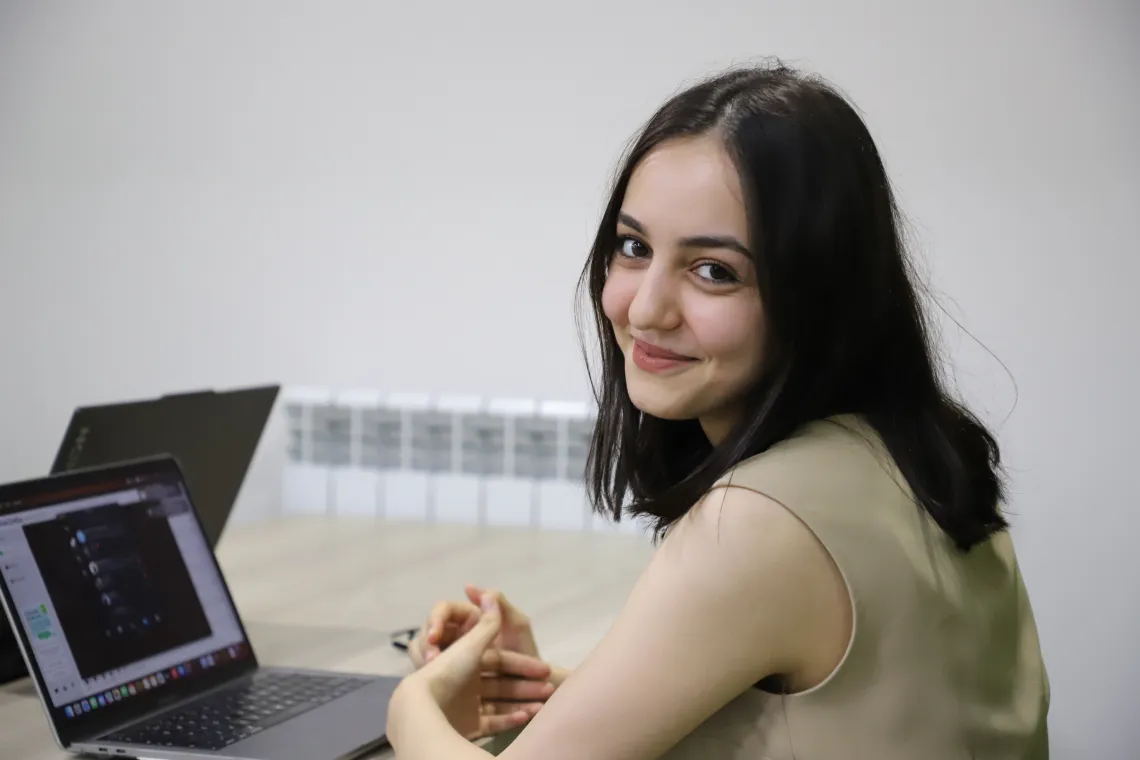 A woman looking at the camera smiling