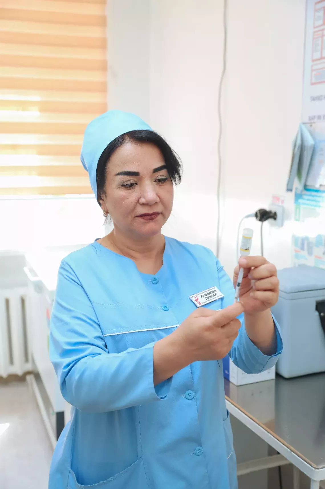 A nurse holding a needle with vaccine