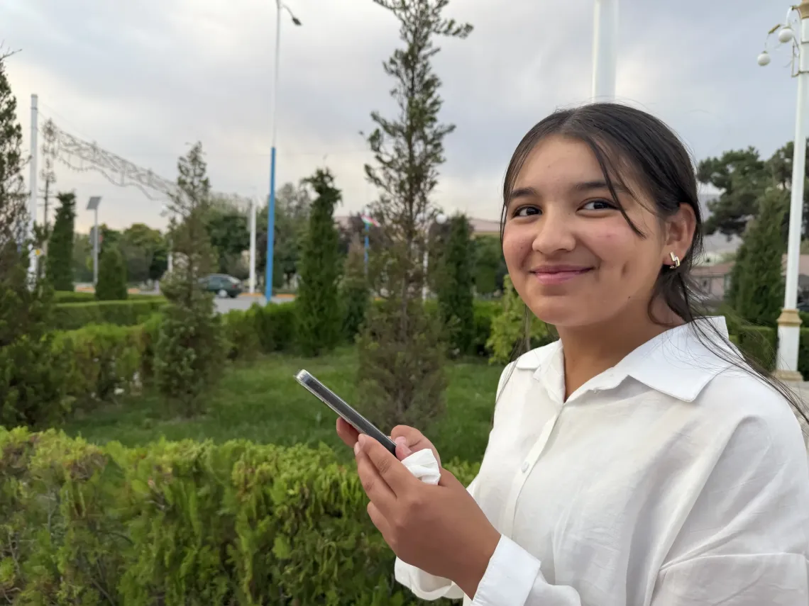 Sumaya smiling at the camera in Panjakent park