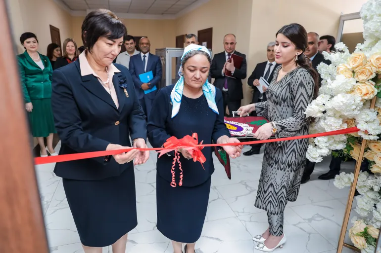 Two women cutting the ribbon