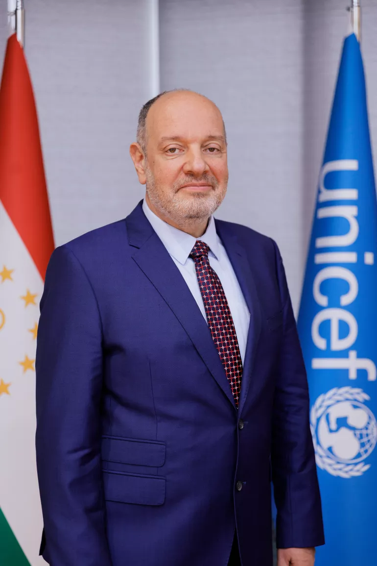 A man standing in front of the camera, smiling 